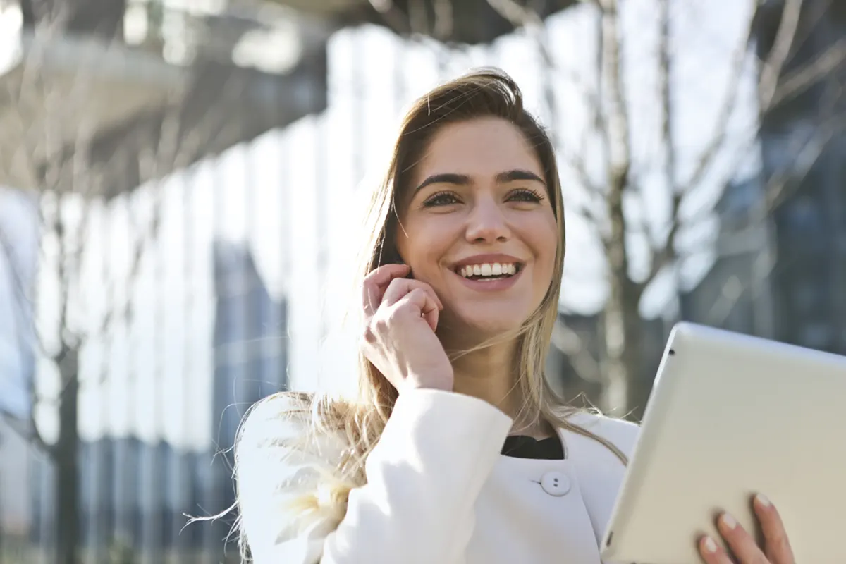 Satisfied Customers: Managed Services Australia in Melbourne A happy customer smiling and holding a tablet in Melbourne