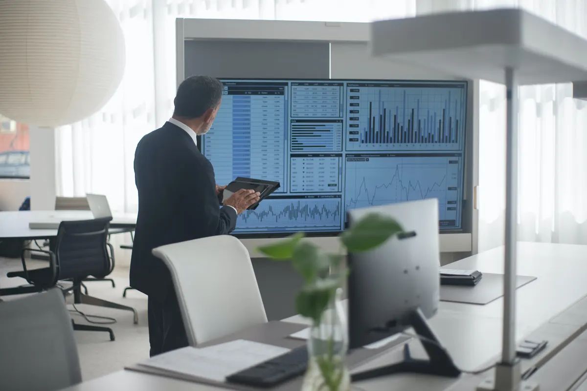 A photograph of a group of professional services executives in a boardroom presentation, using technology supplied by Managed Services Australia in Melbourne.