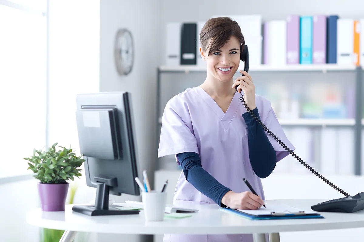 A doctor using a VoIP phone in her medical practice in Melbourne
