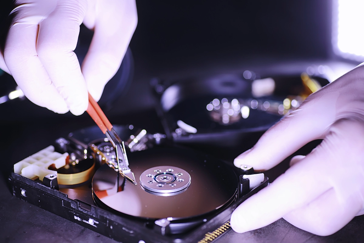 Engineer_repairing_mechanical_hard_drive_Managed_Services_Australia