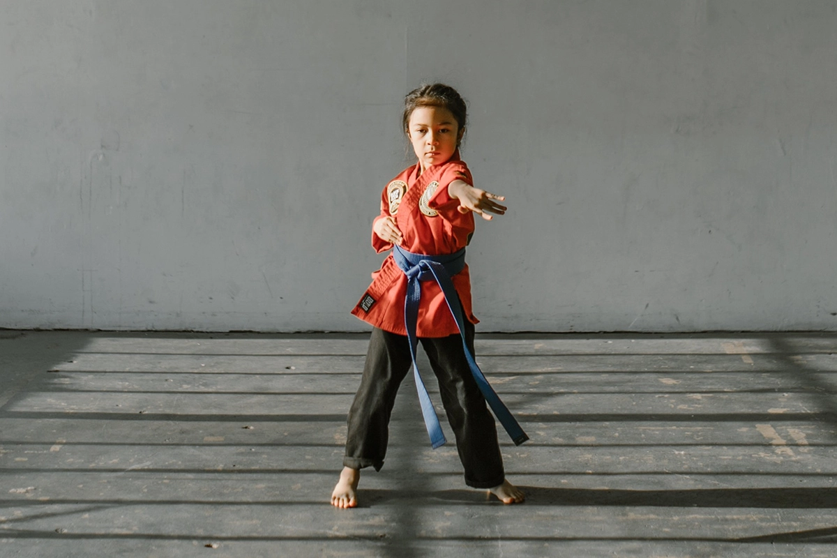 A child performing martial arts representing the importance of strong defense against cybersecurity threats
