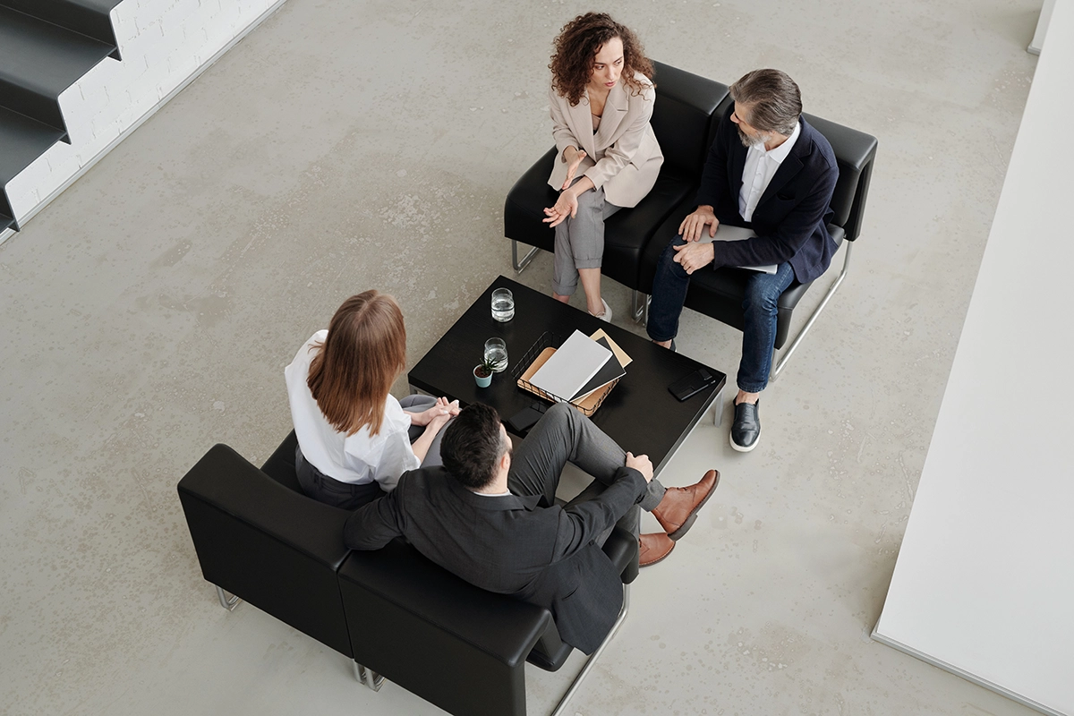 Strategic Consultation – Management Team Meeting in a Lounge Management_consultants_team_meeting_Managed_Services_Australia