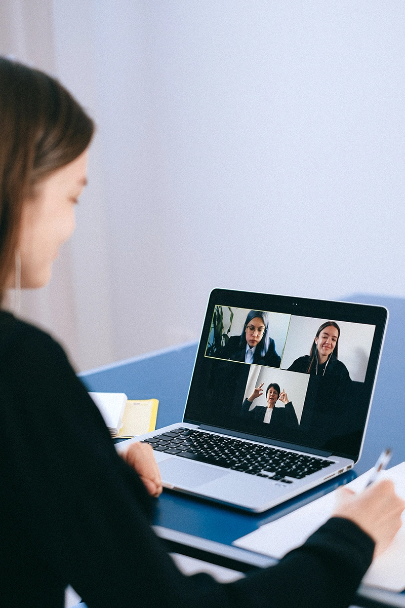 Online Learning – Student Engaging in a Teams Meeting Student_writing_notes_teams_meeting_Managed_Services_Australia